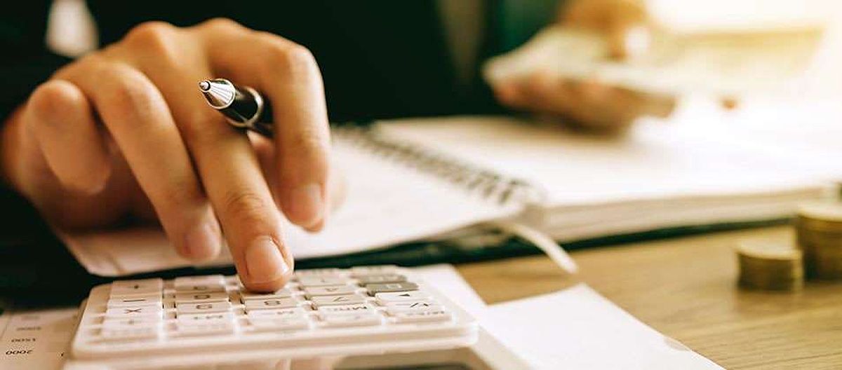 Closeup of hand using calculator.